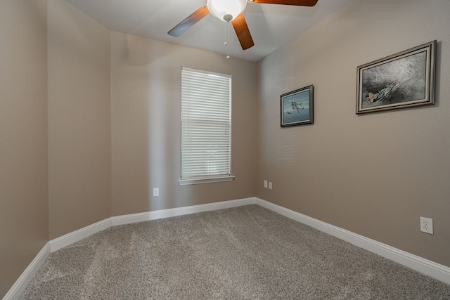 carpeted spare room featuring ceiling fan