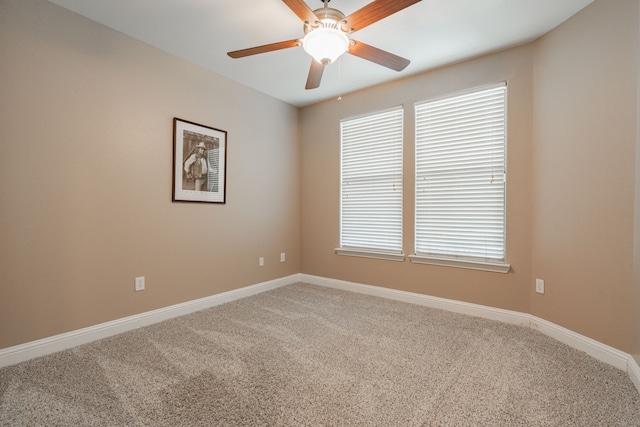 carpeted empty room featuring ceiling fan