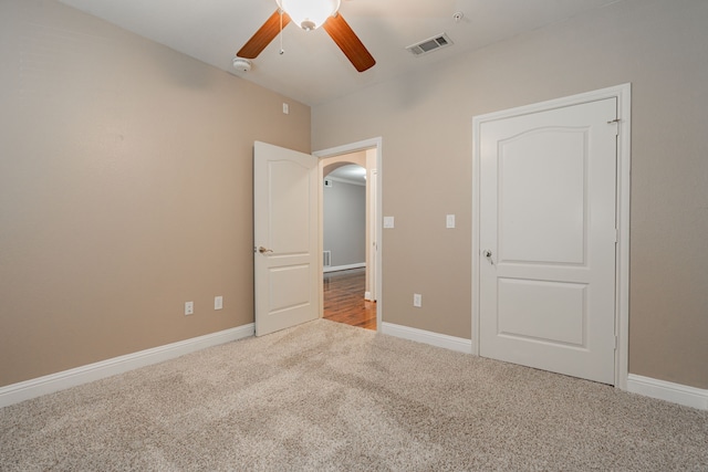 unfurnished bedroom with ceiling fan and carpet