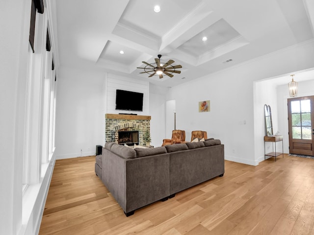 living area with a fireplace, light wood-type flooring, coffered ceiling, and baseboards