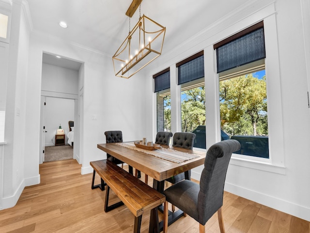 dining space with baseboards, a healthy amount of sunlight, and light wood-style flooring