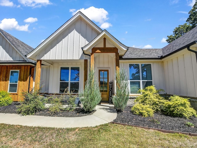 view of front of property with board and batten siding and roof with shingles