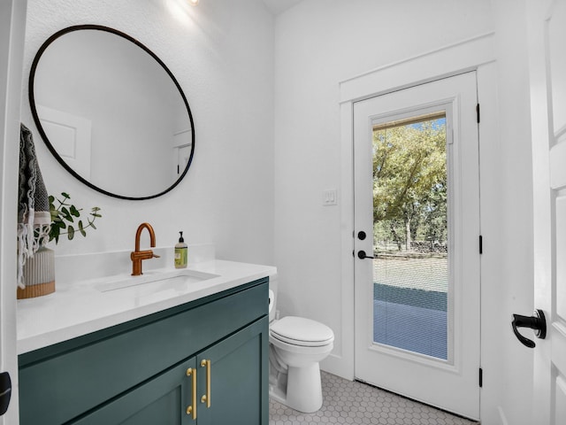 bathroom with tile patterned flooring, toilet, and vanity