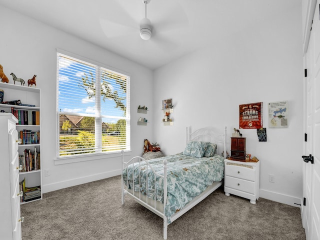 carpeted bedroom featuring a ceiling fan and baseboards