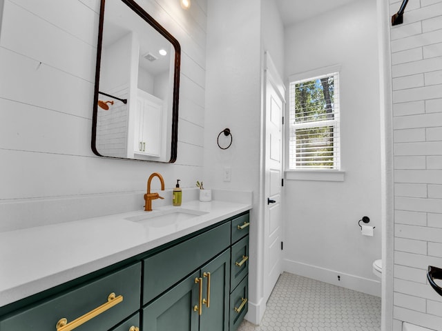 full bathroom with vanity, visible vents, baseboards, tile patterned floors, and toilet