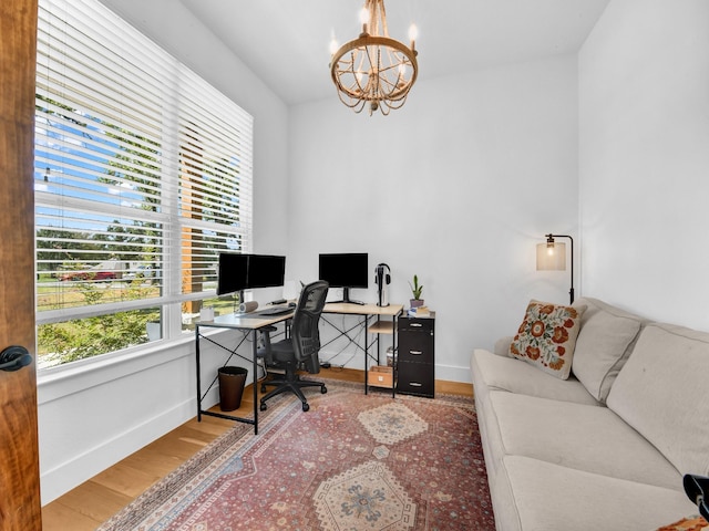 office featuring baseboards, an inviting chandelier, and wood finished floors