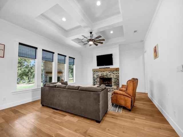 living room with a brick fireplace, a healthy amount of sunlight, and coffered ceiling