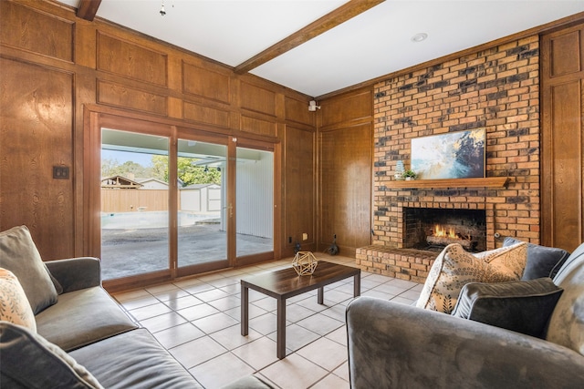 living room with a fireplace, wooden walls, light tile patterned floors, and beam ceiling