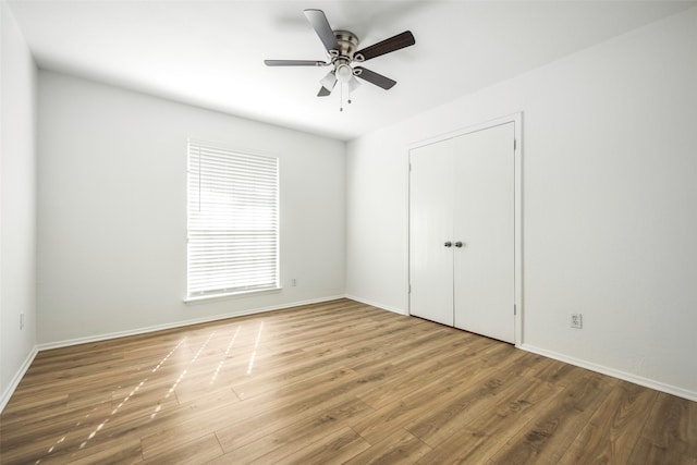 unfurnished bedroom featuring wood-type flooring and ceiling fan