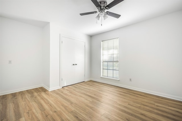 empty room featuring ceiling fan and light hardwood / wood-style floors