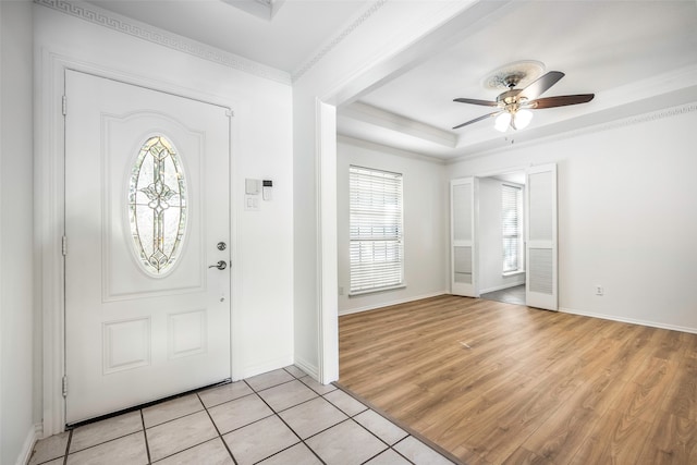 foyer entrance featuring ceiling fan, light hardwood / wood-style flooring, and ornamental molding