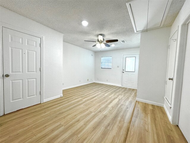 interior space with a textured ceiling, light hardwood / wood-style flooring, and ceiling fan