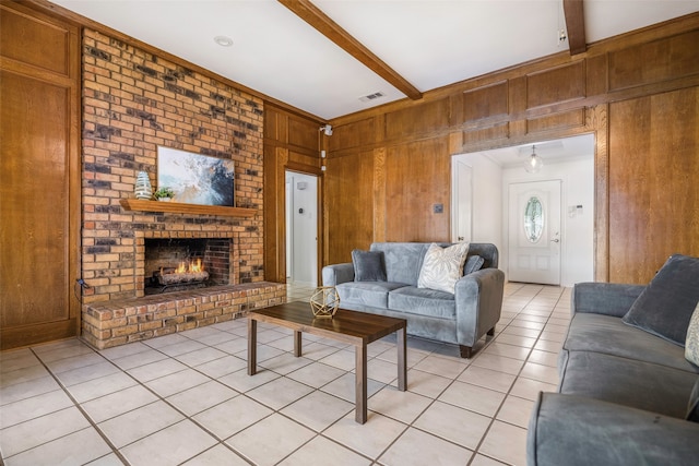 living room with a brick fireplace, wood walls, beamed ceiling, and light tile patterned flooring