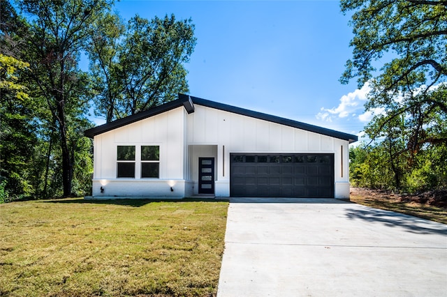 view of front of house with a front yard and a garage