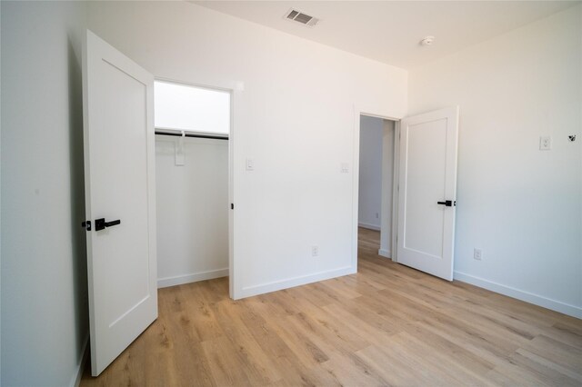 full bathroom featuring hardwood / wood-style floors, tiled shower / bath combo, vanity, and toilet