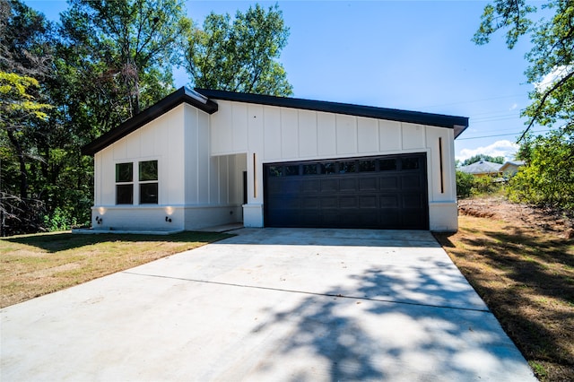 view of front of property with a front yard and a garage