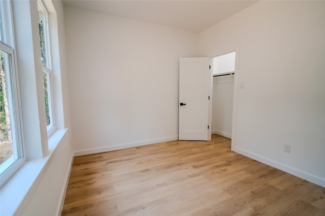 unfurnished room with light hardwood / wood-style floors and plenty of natural light