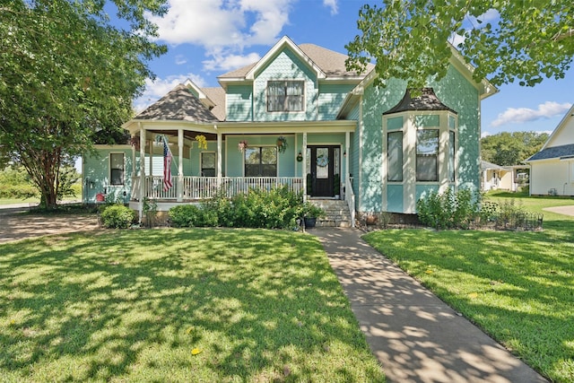 view of front of house featuring covered porch and a front lawn