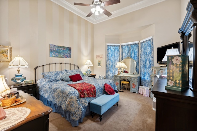 carpeted bedroom with ceiling fan and ornamental molding