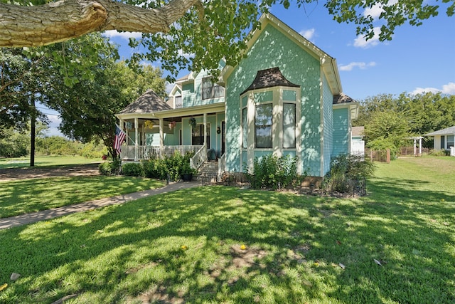 victorian house featuring a front yard and a porch