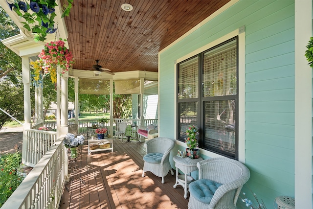 wooden terrace featuring ceiling fan and covered porch