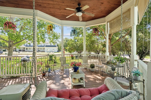 sunroom / solarium with ceiling fan and wooden ceiling