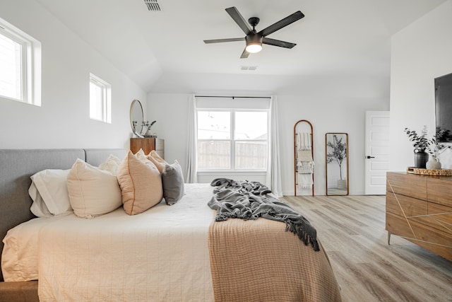 bedroom featuring ceiling fan, light hardwood / wood-style floors, and vaulted ceiling