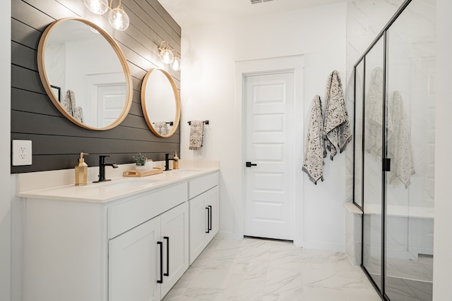 bathroom featuring vanity, a shower with shower door, and wood walls