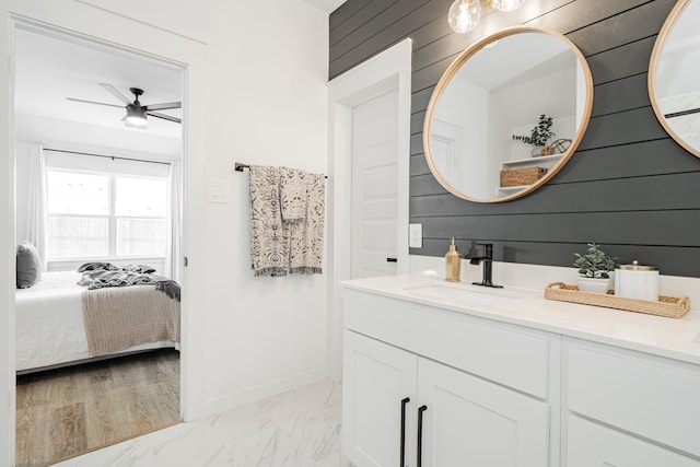 bathroom with vanity, ceiling fan, wooden walls, and wood-type flooring