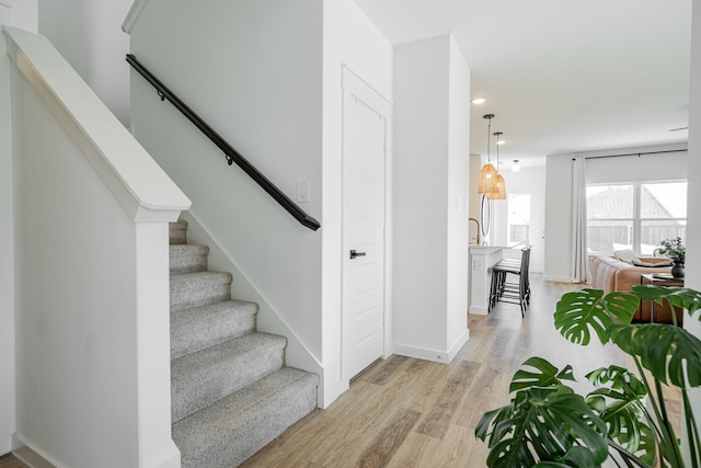 staircase featuring wood-type flooring