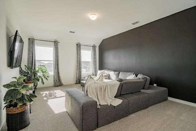 bedroom with lofted ceiling and light colored carpet