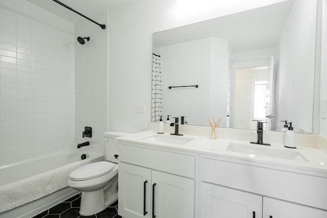 full bathroom featuring tiled shower / bath, vanity, toilet, and tile patterned flooring