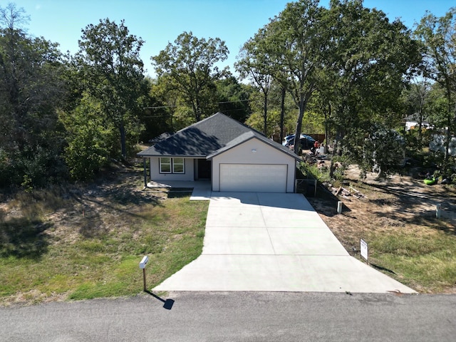 single story home with a garage and a front lawn