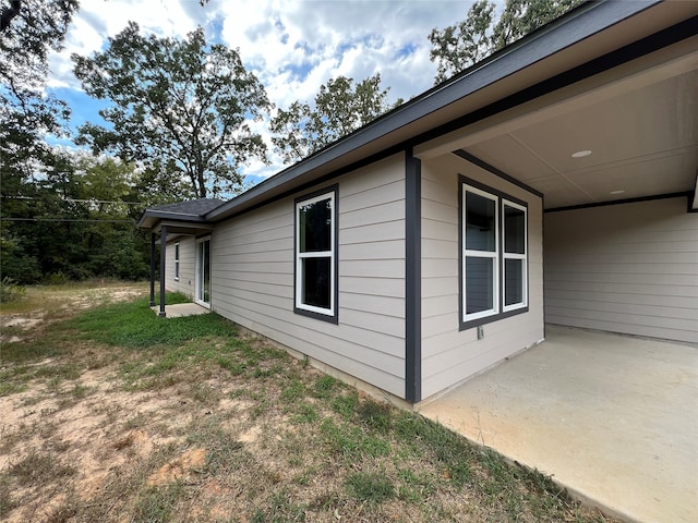 view of side of home featuring a patio