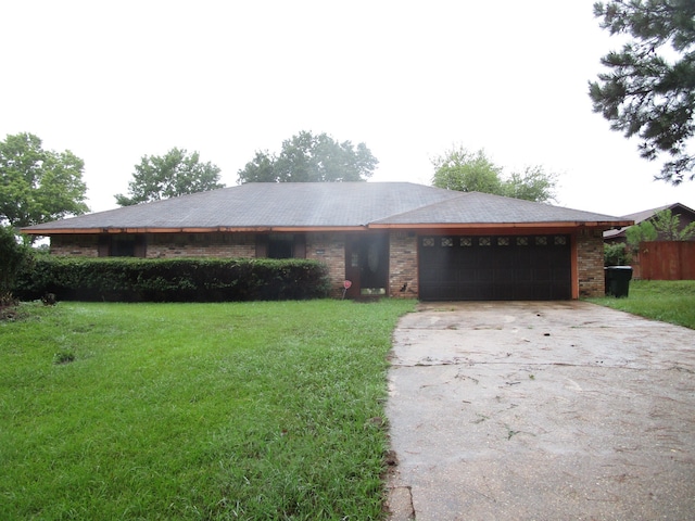 ranch-style home with a garage and a front yard