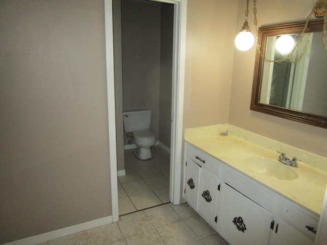 bathroom featuring tile patterned floors, toilet, and vanity