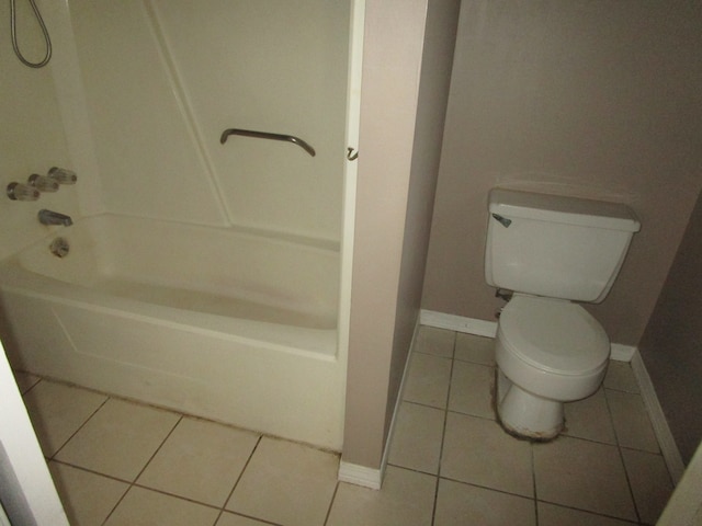 bathroom featuring tub / shower combination, toilet, and tile patterned flooring