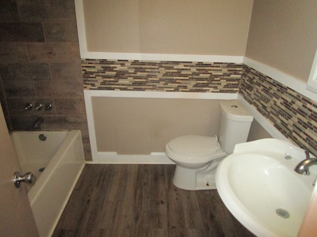 bathroom featuring toilet, hardwood / wood-style floors, sink, and backsplash