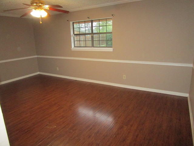 empty room featuring ornamental molding, dark wood-type flooring, a textured ceiling, and ceiling fan