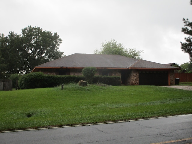 ranch-style home with a front lawn