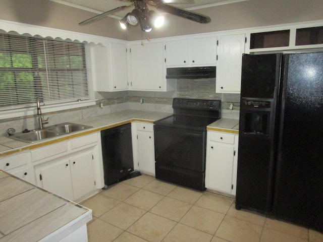 kitchen with white cabinetry, tile counters, black appliances, sink, and ceiling fan