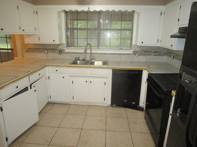 kitchen featuring tile counters, black appliances, sink, and white cabinets