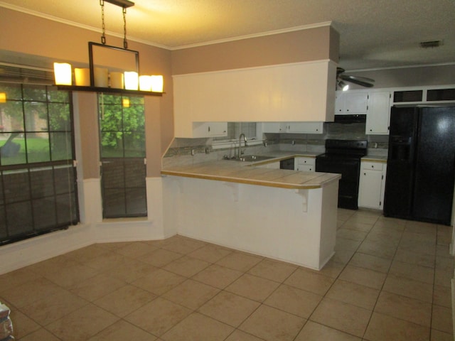 kitchen featuring white cabinetry, black appliances, kitchen peninsula, sink, and ceiling fan