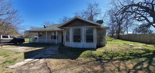 view of front of home with a porch and a front yard