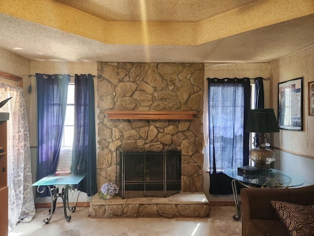 unfurnished living room featuring a fireplace, a textured ceiling, and concrete floors