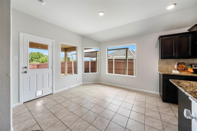 kitchen with a center island with sink, light colored carpet, sink, and fridge