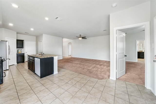 kitchen with stainless steel refrigerator, ceiling fan, sink, white dishwasher, and dark brown cabinets