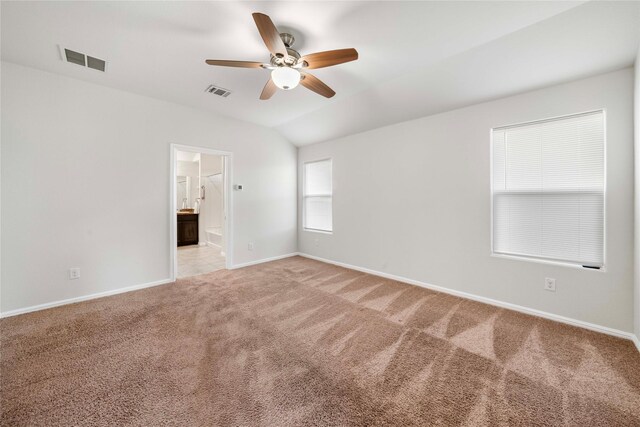 carpeted spare room with vaulted ceiling and ceiling fan