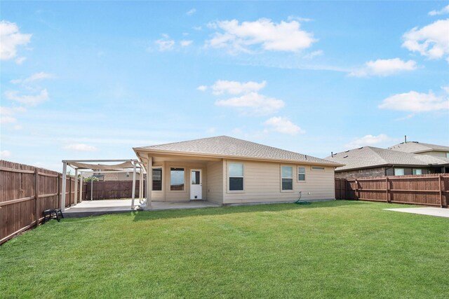 back of house featuring a lawn and a patio area