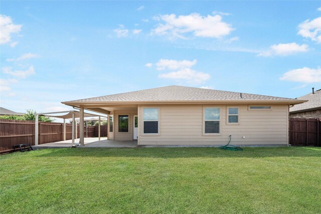 back of property with a lawn and a patio area